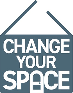 A blue house shaped logo with the words change your space and a door symbol 