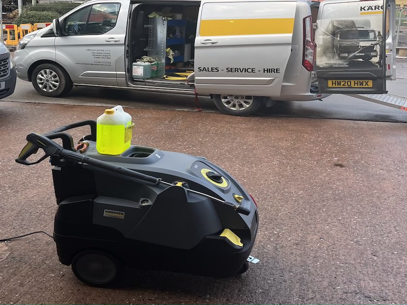 a van and a pressure washed on an industrial estate